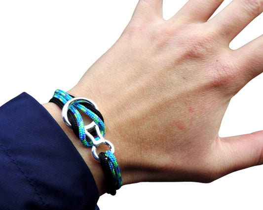 Hand wearing a colorful climbing bracelet on a white background