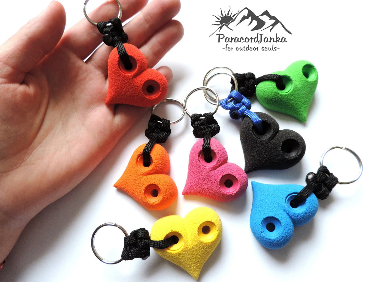 Colorful heart-shaped climbing keychains on a white background with ParacordJunka branding.