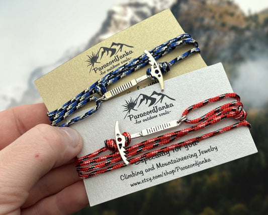 Two climbing bracelets on a card with Paracordianka branding, against a blurred natural background.